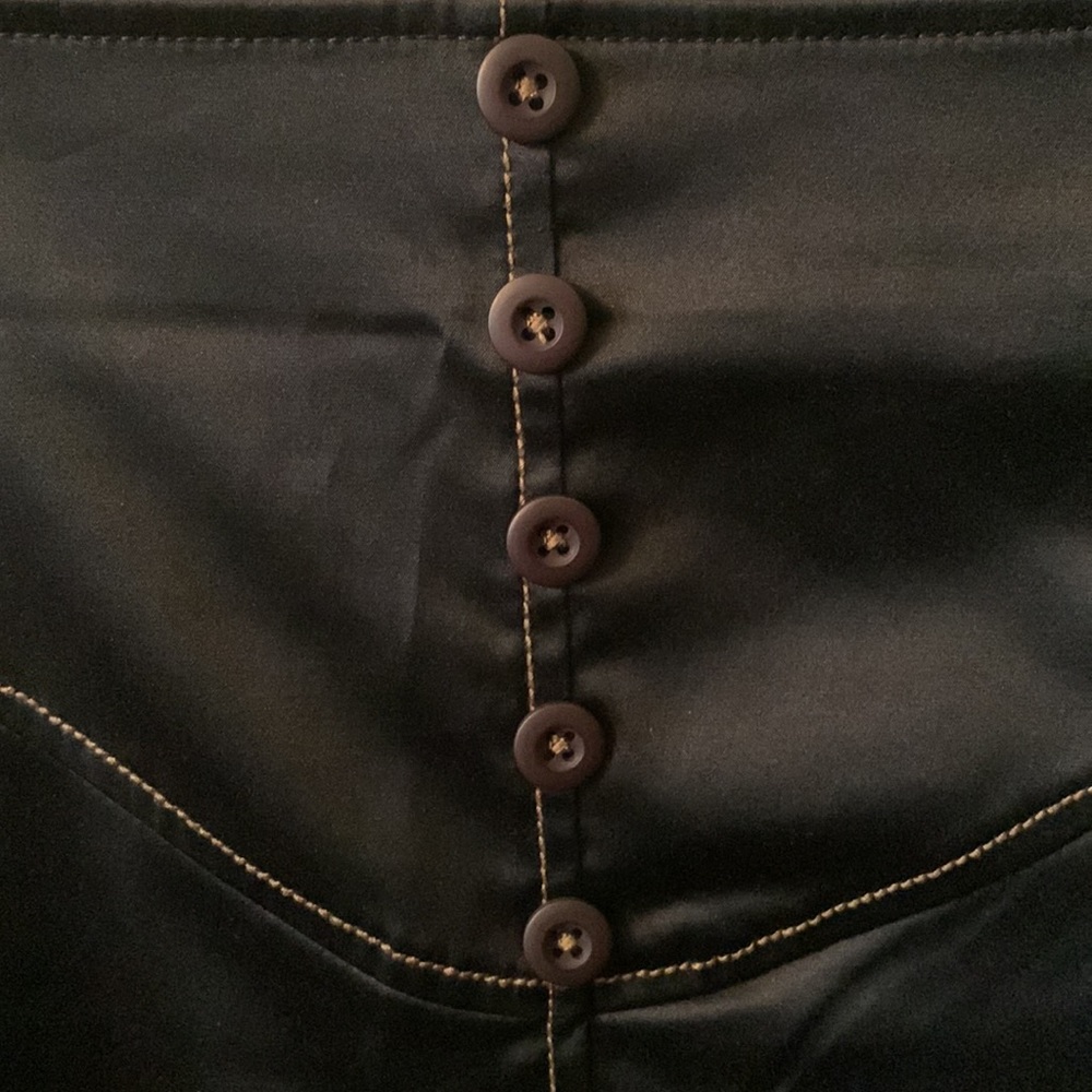 Skunk Funk- black skirt, gold stitching.